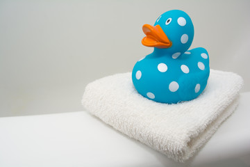Cute Rubber Duck on a White Towel in a Bathroom