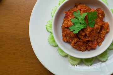 Thai Northern local Style minced Pork and Tomato Relish paste dip. Nam Prik Ong. 
very famous spicy yummy hot chilli pepper paste sauce.
together with vegetable like cucumber. 