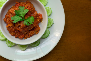 Thai Northern local Style minced Pork and Tomato Relish paste dip. Nam Prik Ong. 
very famous spicy yummy hot chilli pepper paste sauce.
together with vegetable like cucumber. 