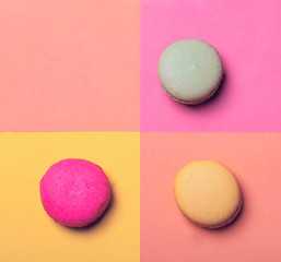 Three macarons on colorful background
