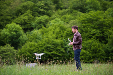 Man handling drone in nature