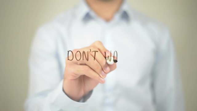 Don't Wait, Man writing on transparent screen