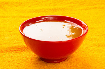 natural honey in a red bowl