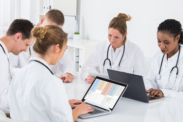 Group Of Doctors Using Laptop