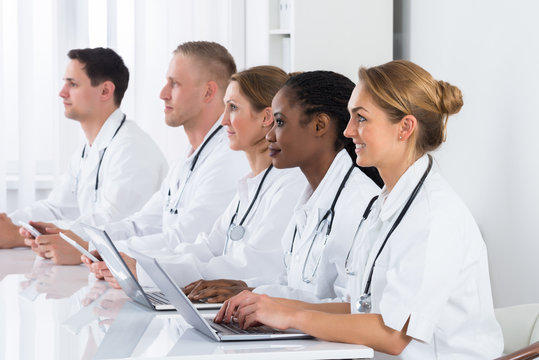 Doctors Using Laptop In Meeting