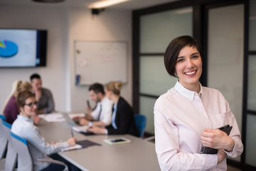 hispanic businesswoman with tablet at meeting room