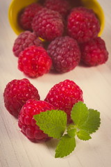 Vintage photo, Fresh raspberries and lemon balm on white wooden table, healthy food