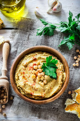 Hummus in wooden bowl  on the table.