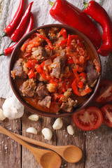 lamb cooked with onion, tomato and pepper closeup. vertical top view
