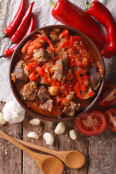 lamb cooked with onion, tomato and pepper closeup. vertical top view
