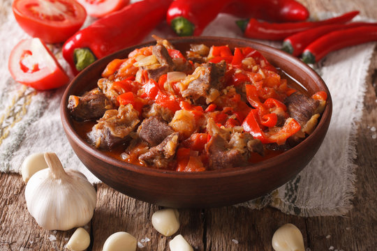 lamb slow stewed with onion, tomato and pepper closeup. horizontal
