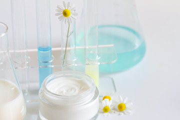 Natural herbal healthy cosmetics in the lab abstract with camomile
