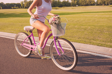 Close up photo of young woman riding cycle on the street