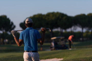 golfer from back at course looking to hole in distance