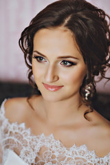Portrait of the bride looking at the camera. Beautiful young brunette. Lace. Serenity