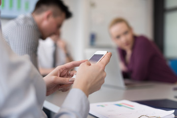 close up of  busineswoman hands  using smart phone on meeting