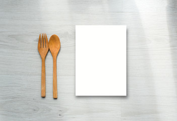 Mock up paper display and wooden spoon and fork on gray wooden f