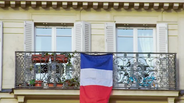 Beautiful balcony with French flag, closeup. Patriotism, love for motherland