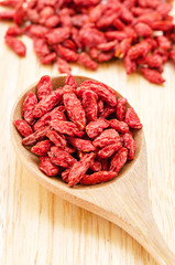 Wooden tablespoon of dried goji berries