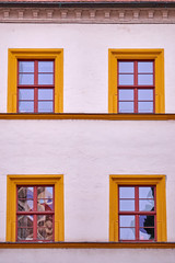 pale white building facade with orange framed windows