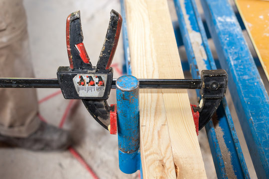 Frame Wall Construction. Closeup Of Clamp Holding Wooden Beam