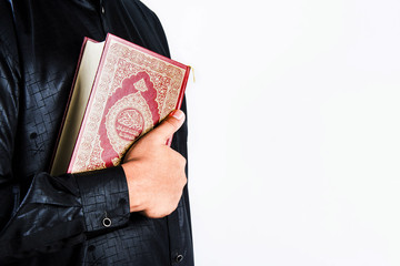 Koran in hand ,Quran in hand - holy book of Muslims , on white background