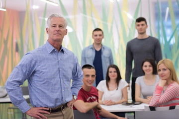 portrait of  teacher with students group in background
