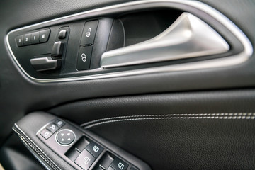 Obraz na płótnie Canvas luxury car control buttons - door panel ; Interior details. 