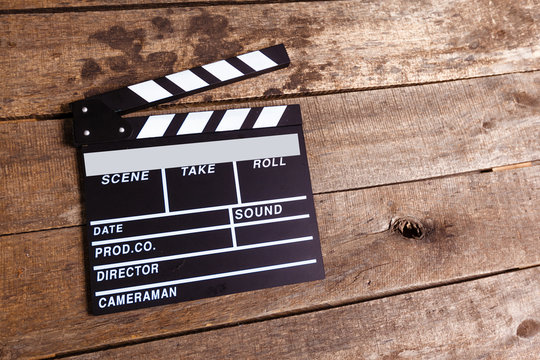 photo of movie clapper on wood