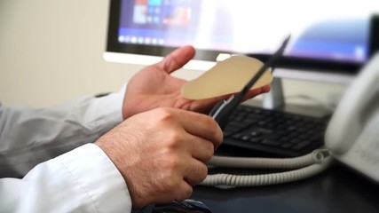 Plastic surgeon demonstrates with breast implant.