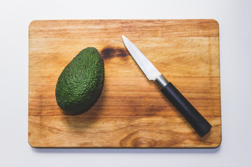 Avocado and knife on a chopping table