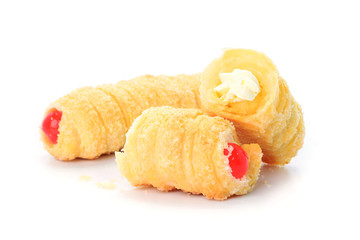 Cream filled pastry roll on white background
