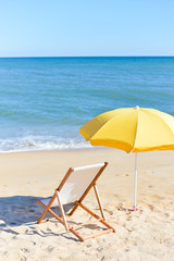Back View Of Deckchair, Sun Lounger Under Umbrella On Sand Beach. 