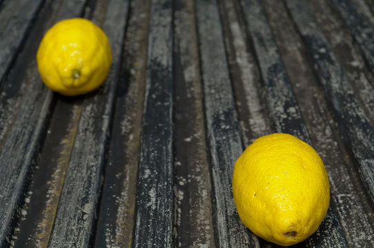 Raw textured black Background backdrop with lemon and lime