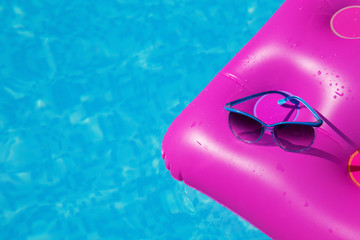 Sunglasses pink air mattress swimming pool. Tropical concept