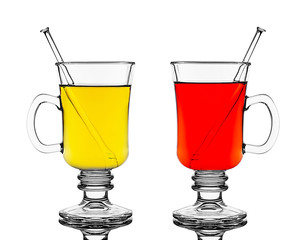 Two glasses with red and yellow hot wine