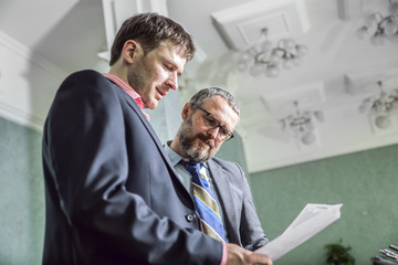 Fototapeta premium two businessmen talking in office