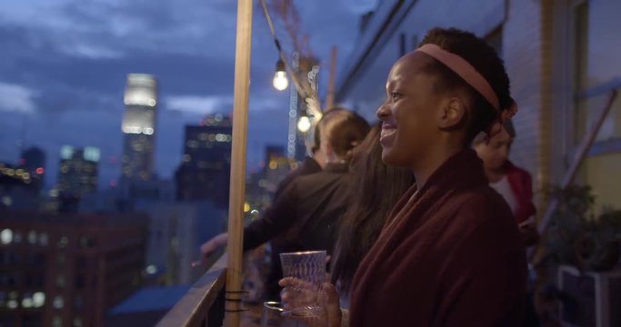 Petite woman with dark skin smiling at a party in Downtown Los Angeles, California.  Recorded in slow motion at 60fps.