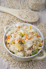 Rice with vegetables on white background