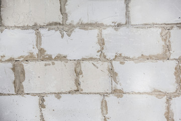 a wall of large grey cinder blocks