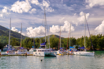 Fototapeta na wymiar White yachts in the port at sunrise, Praslin, Seychelles