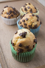 Muffins with chocolate on a wooden table