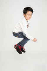 Asian cute boy is jumping with smile face