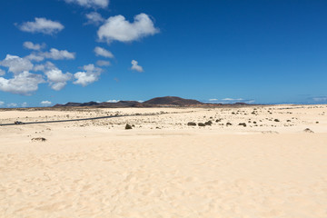 Corralejo sand dunes and extinct volcanoes  in the background. Fuerteventura, Canary Islands, Spain