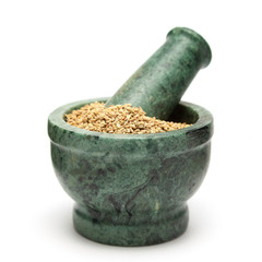 Organic Carom or Ajwain (Trachyspermum ammi) on marble pestle Isolated on white background.