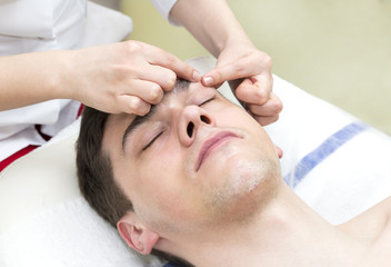 Fototapeta na wymiar man in the mask cosmetic procedure in spa salon