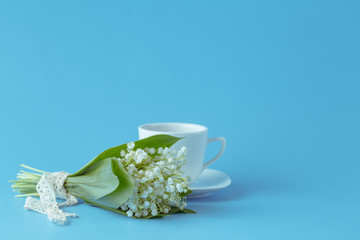 Flower lily of the valley on a blue background