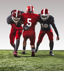 The three american football players in action