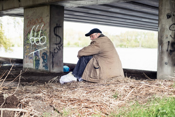 Wanderer sitting under bridge.