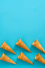 Empty ice cream cornets on blue background
